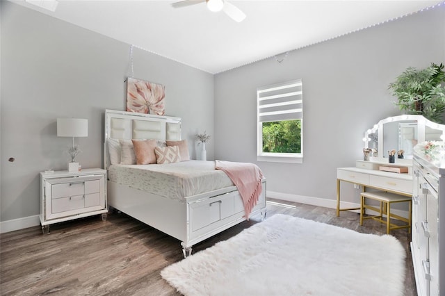 bedroom with ceiling fan and dark wood-type flooring