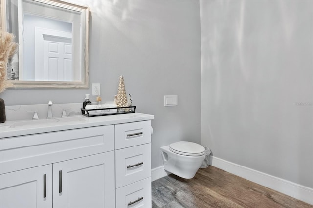 bathroom featuring hardwood / wood-style floors, vanity, and toilet