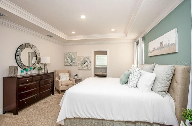 bedroom with crown molding, a tray ceiling, and light carpet