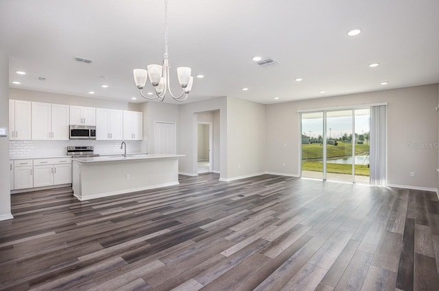 kitchen featuring decorative light fixtures, white cabinetry, sink, decorative backsplash, and stainless steel appliances