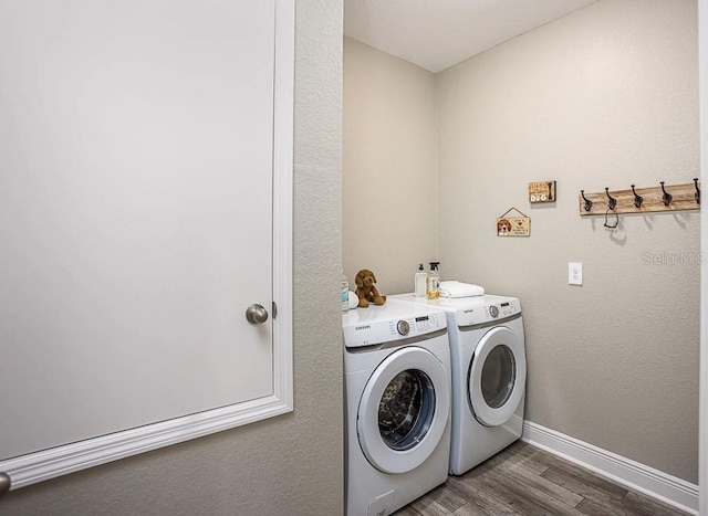 laundry room featuring dark hardwood / wood-style floors and washing machine and dryer