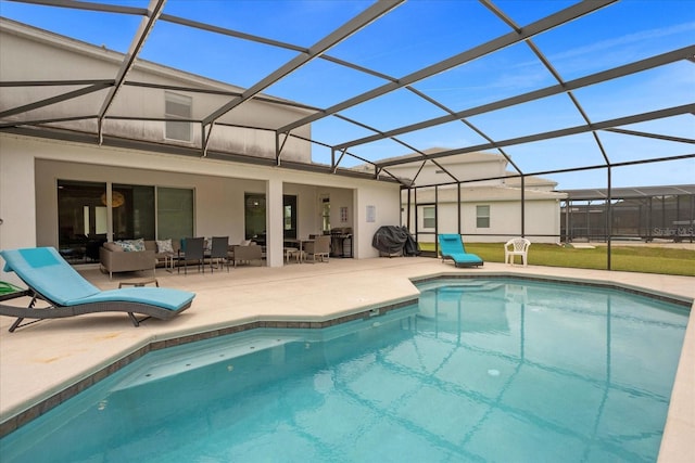 view of swimming pool with a grill, a patio, outdoor lounge area, and glass enclosure