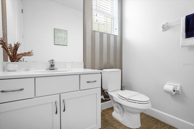 bathroom featuring vanity, toilet, and hardwood / wood-style floors