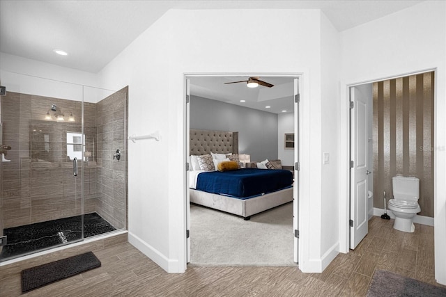 bathroom with vaulted ceiling, a shower with shower door, hardwood / wood-style floors, and toilet