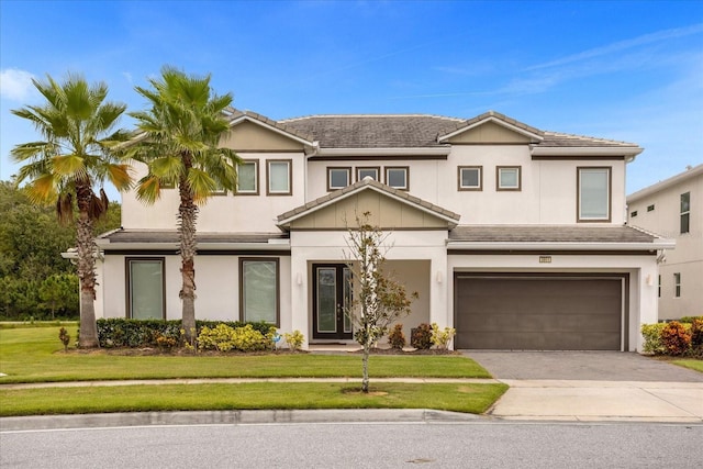 view of front facade with a garage and a front lawn