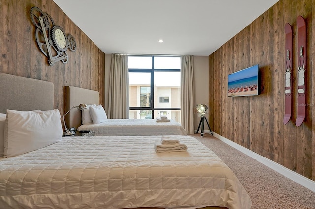 bedroom featuring carpet and wooden walls