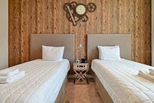 carpeted bedroom with wooden walls