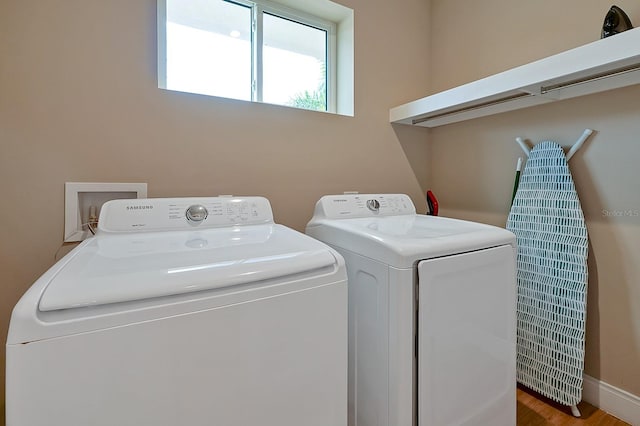 laundry area featuring washer hookup, washer and dryer, and light wood-type flooring