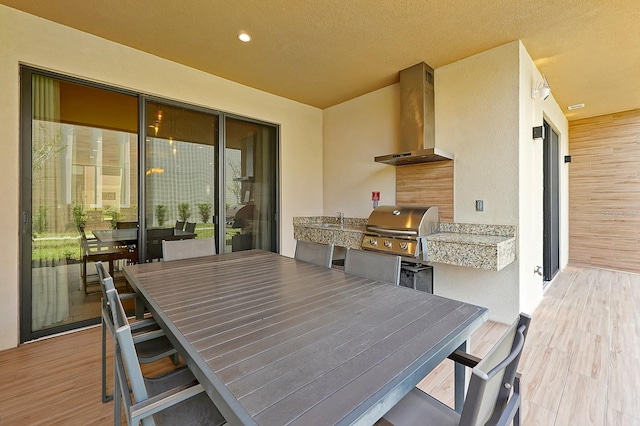 exterior space with a textured ceiling and light hardwood / wood-style flooring