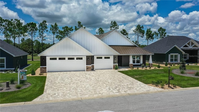 view of front of home with a front lawn and a garage