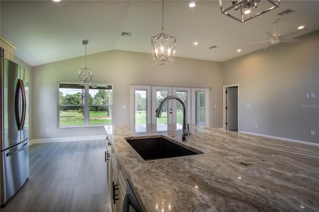 kitchen featuring pendant lighting, french doors, stainless steel fridge, dark hardwood / wood-style floors, and sink