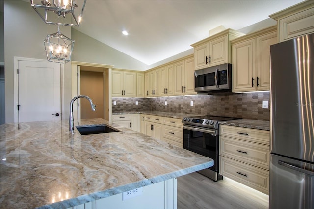 kitchen featuring tasteful backsplash, stainless steel appliances, sink, and light stone counters