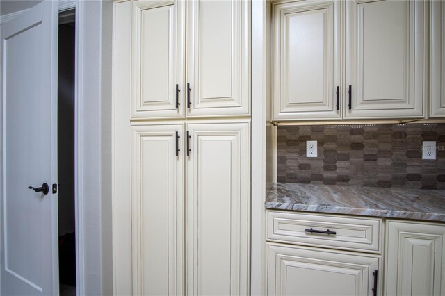 kitchen featuring tasteful backsplash and white cabinets