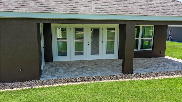 property entrance featuring a patio, french doors, and a yard