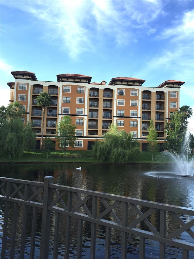 view of property featuring a water view and fence