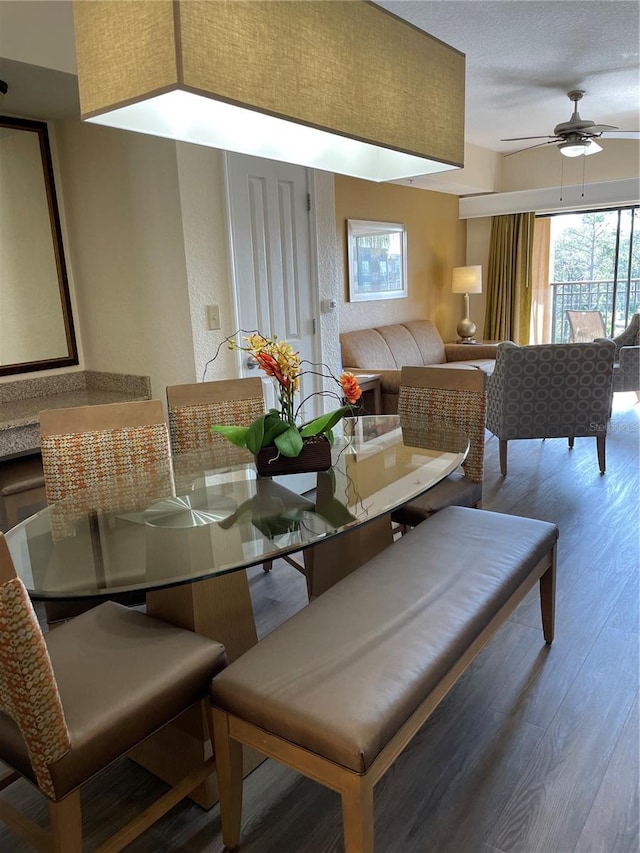 dining area with ceiling fan and wood finished floors