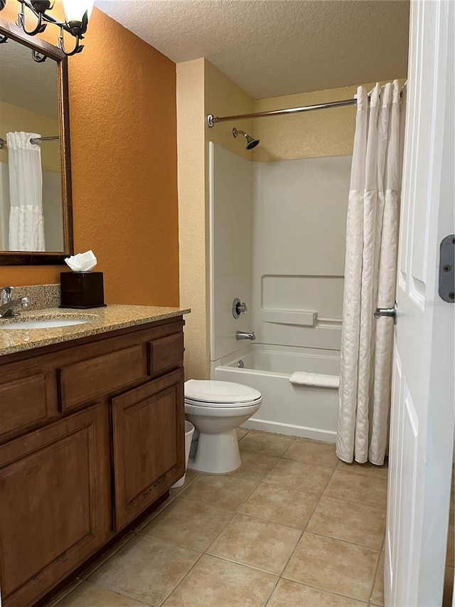 full bath featuring a textured ceiling, a textured wall, toilet, vanity, and tile patterned floors