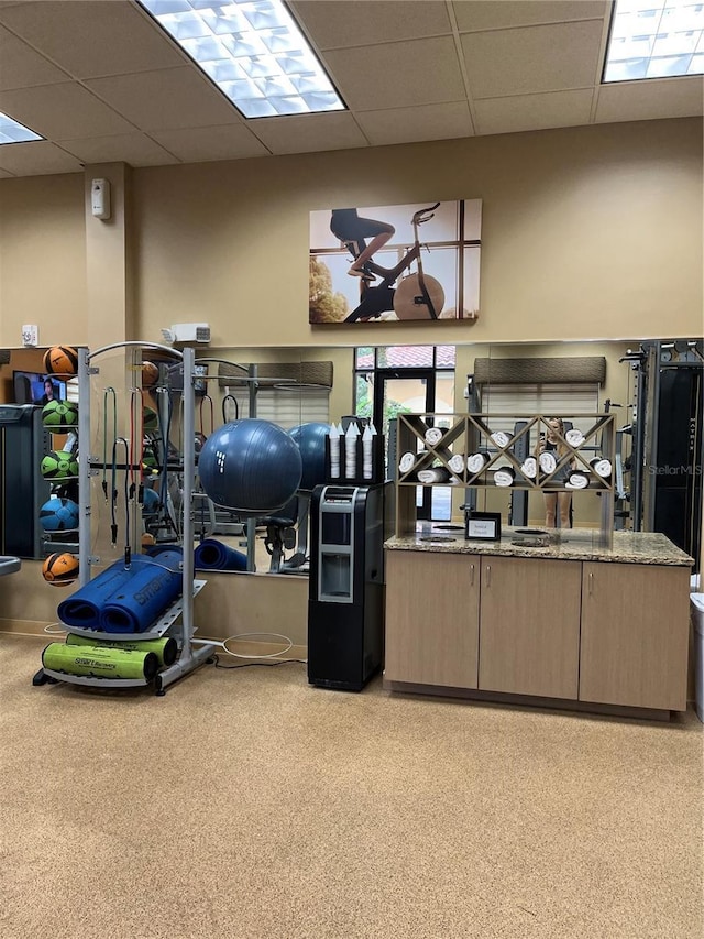 exercise room featuring a drop ceiling