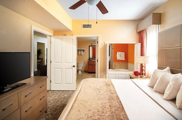 12521 Floridays Resort Dr Unit 302F, Orlando, FL 32821 - bedroom with ensuite bath and ceiling fan