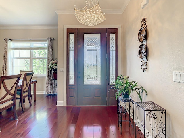 foyer entrance featuring a notable chandelier, dark hardwood / wood-style flooring, and crown molding