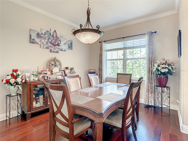 dining room featuring ornamental molding and dark hardwood / wood-style flooring