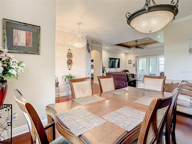 dining area featuring ceiling fan, a tray ceiling, crown molding, hardwood / wood-style floors, and french doors