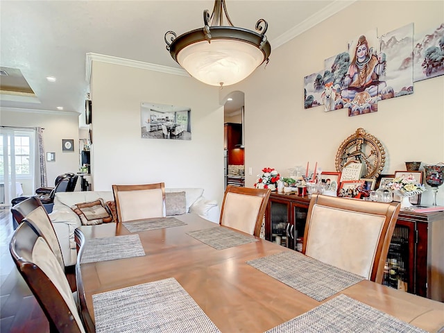 dining room featuring crown molding