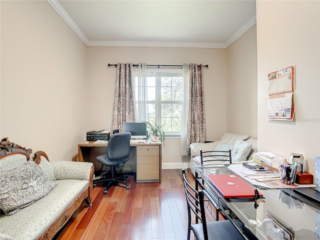 office space with ornamental molding and light hardwood / wood-style flooring