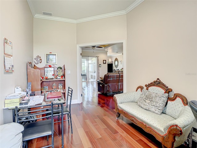 home office featuring hardwood / wood-style floors, ornamental molding, and ceiling fan