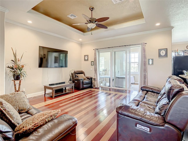 living room featuring crown molding, ceiling fan, a raised ceiling, and hardwood / wood-style floors