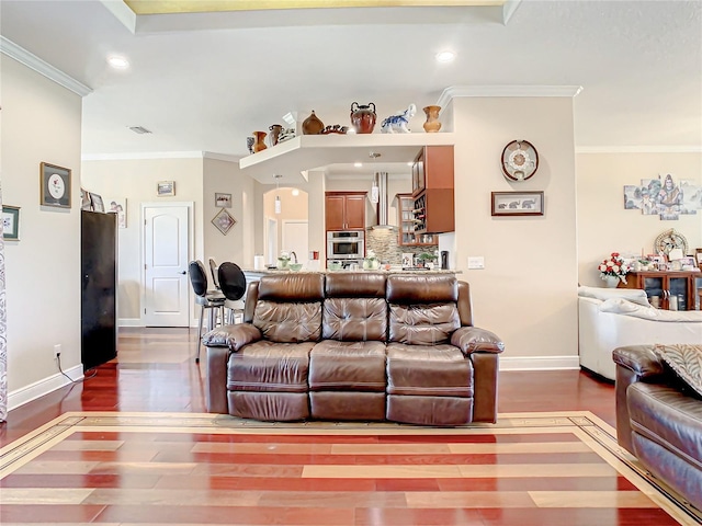 living room with dark hardwood / wood-style flooring and crown molding