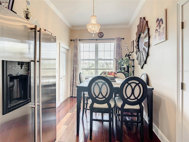 dining room with ornamental molding and hardwood / wood-style flooring