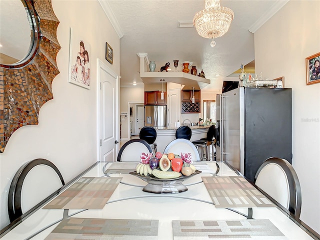 dining space featuring a notable chandelier and crown molding