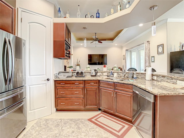 kitchen with light tile flooring, ceiling fan, a tray ceiling, light stone countertops, and appliances with stainless steel finishes