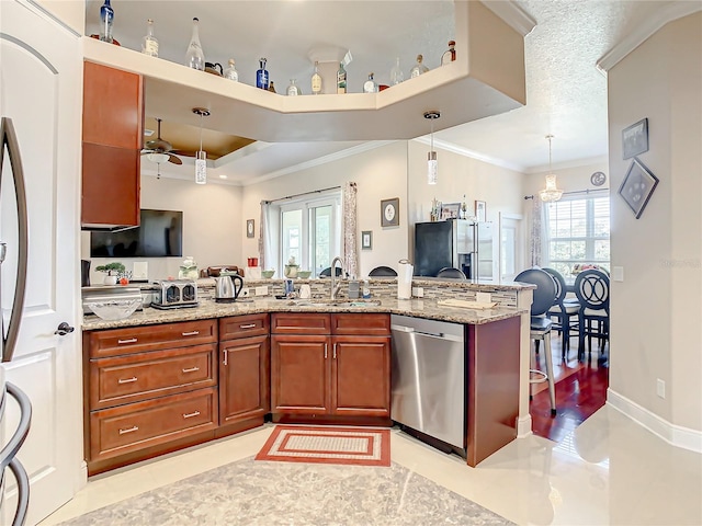 kitchen featuring dishwasher, light stone counters, plenty of natural light, and ceiling fan