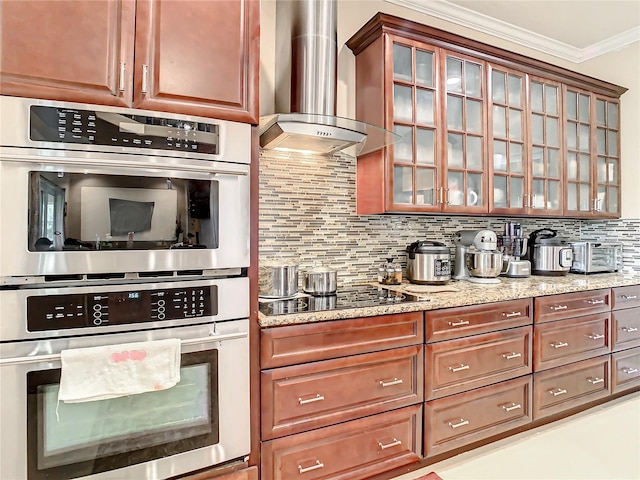 kitchen featuring crown molding, tasteful backsplash, black electric cooktop, wall chimney exhaust hood, and stainless steel double oven