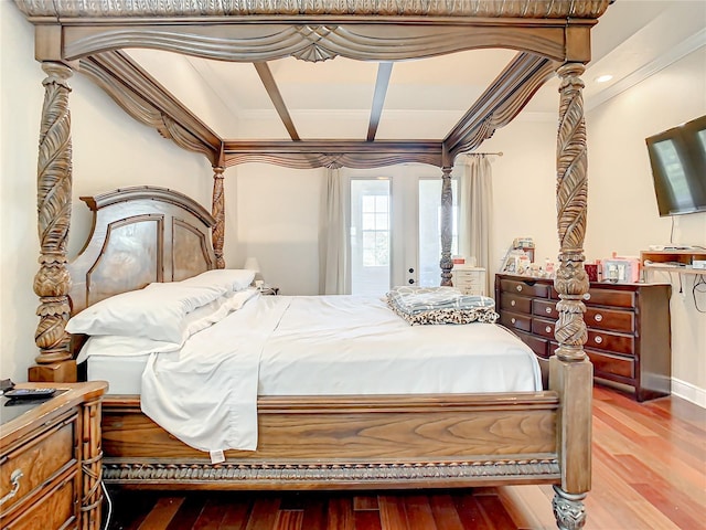 bedroom featuring ornamental molding, hardwood / wood-style floors, and access to outside