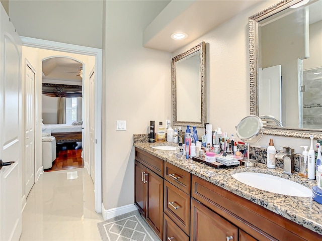 bathroom with tile flooring, double sink, ceiling fan, and large vanity