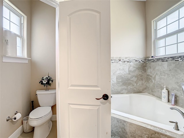 bathroom with tiled bath and toilet