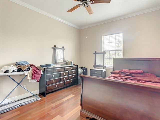 bedroom featuring ceiling fan, light hardwood / wood-style floors, and ornamental molding