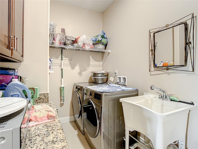 laundry room featuring hookup for a washing machine, sink, separate washer and dryer, and cabinets