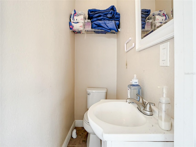 bathroom featuring sink, tile flooring, and toilet