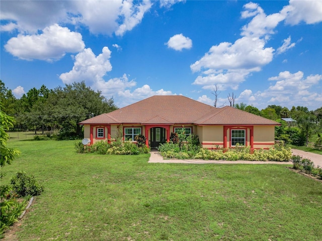 ranch-style home featuring a front lawn