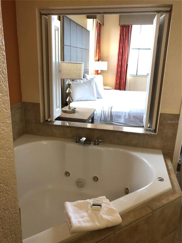 bathroom featuring a relaxing tiled tub