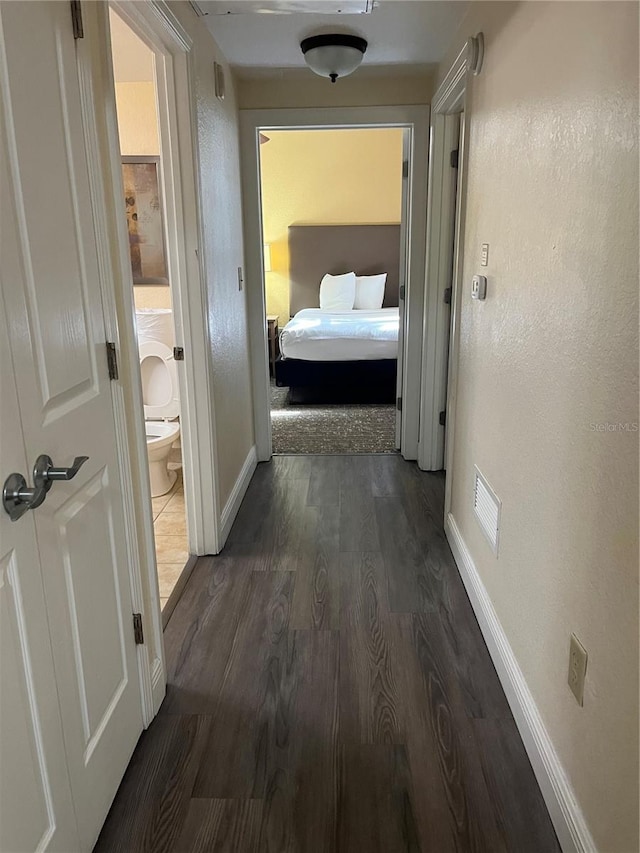 hallway with dark hardwood / wood-style floors