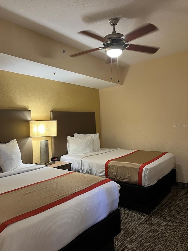 bedroom with ceiling fan and carpet