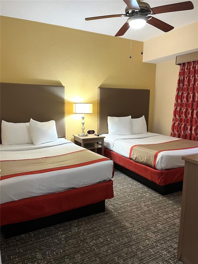 carpeted bedroom featuring ceiling fan