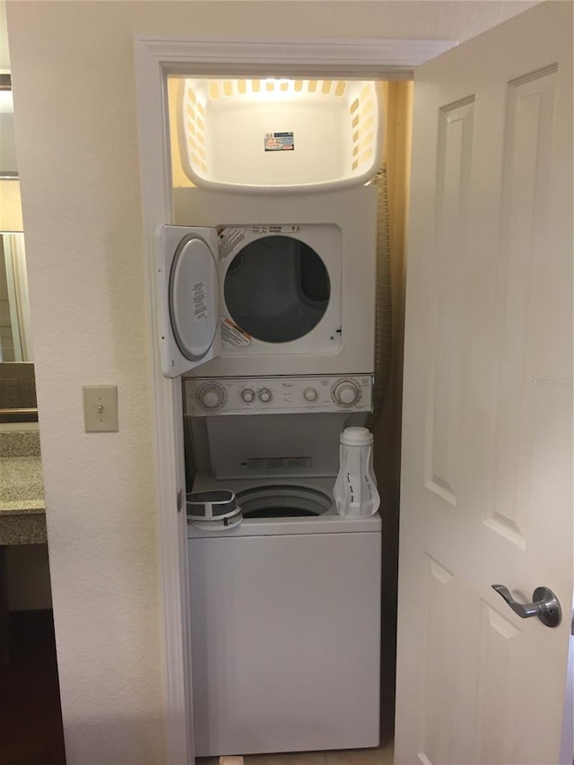 washroom featuring stacked washer and dryer