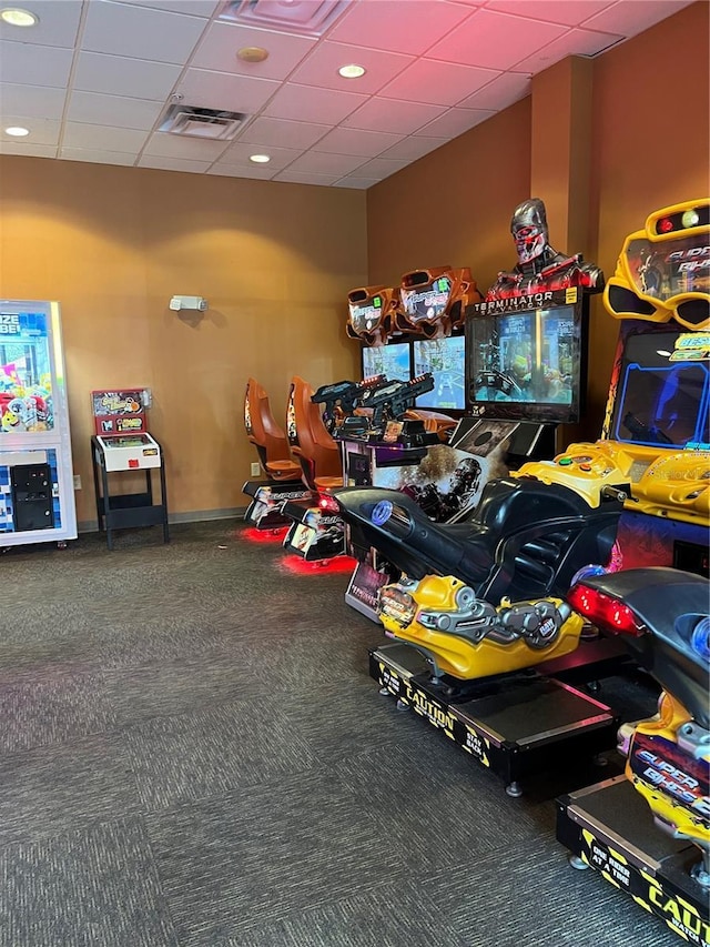 rec room featuring carpet and a drop ceiling