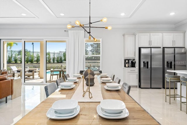 dining space featuring a chandelier, light tile flooring, and ornamental molding